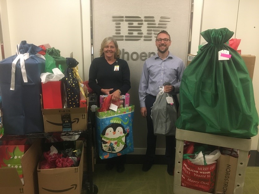 IBM employees pose with gifts they collected for this years Giving Tree Program.