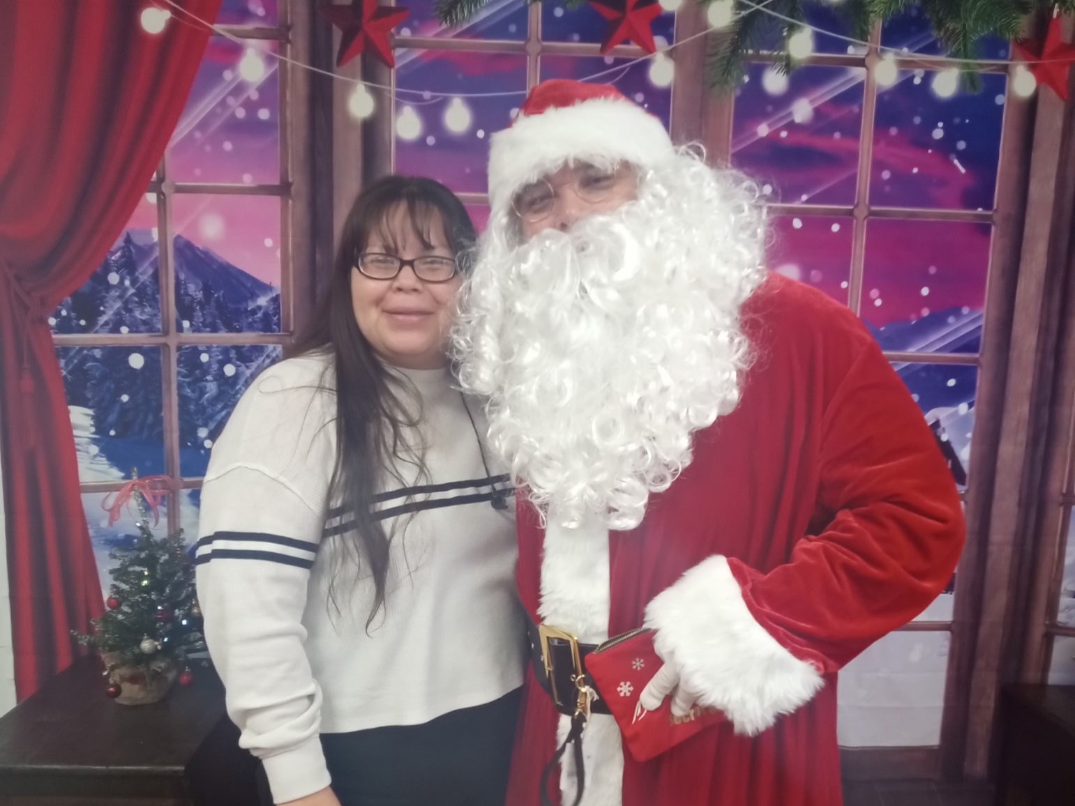 Anna smiling with Santa Claus.