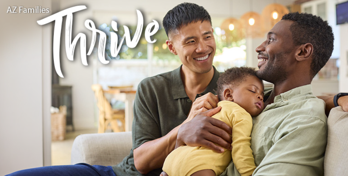 AZ Thrive Newsletter of two dads smiling at each other while one holds a sleeping baby