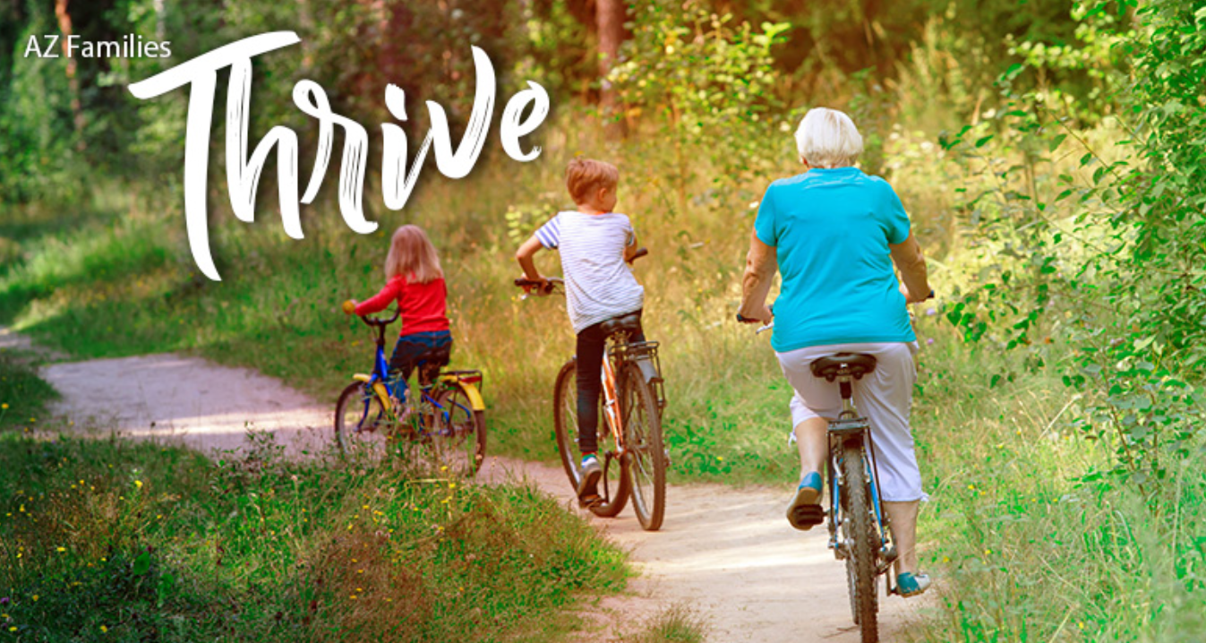 AZ Thrive Newsletter of a grandma and granddaughter riding bikes in the forest